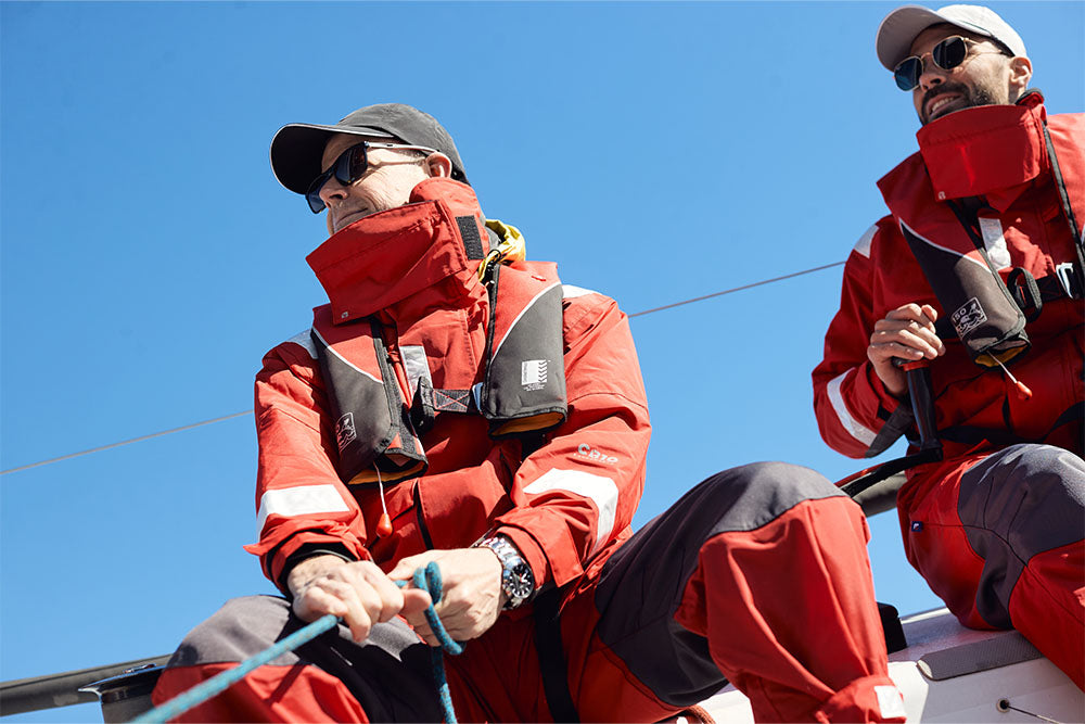 Two people sailing in Burke lifejackets and wet weather gear